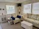 Bright living room with wicker furniture and neutral decor, offering a relaxing space at 3710 Gulf Of Mexico Dr # A20, Longboat Key, FL 34228
