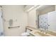 Bathroom featuring a shower with a curtain and a sink with a large mirror at 3916 Chatsworth Greene # 3, Sarasota, FL 34235