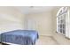 Bedroom with neutral carpet, window with arched transom, and closet at 3916 Chatsworth Greene # 3, Sarasota, FL 34235