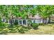 Exterior view of the home, surrounded by lush trees and landscaping at 3916 Chatsworth Greene # 3, Sarasota, FL 34235