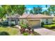 Well-maintained home featuring a two-car garage and mature landscaping at 3916 Chatsworth Greene # 3, Sarasota, FL 34235