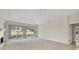Bright living room featuring a fireplace and sliding doors to a screened-in patio with golf course views at 3916 Chatsworth Greene # 3, Sarasota, FL 34235