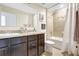Well lit bathroom featuring a shower-tub combo, double sink vanity, and tile floors at 4010 Lindever Ln, Palmetto, FL 34221