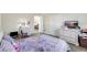 Large bedroom with a purple theme, featuring hardwood floors, a comfortable bed and unique decor at 4010 Lindever Ln, Palmetto, FL 34221