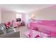 Bright and whimsical bedroom features contemporary colors, unique lighting, and comfortable layout at 4010 Lindever Ln, Palmetto, FL 34221