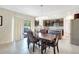 Open dining area features modern chandelier and view of a well-equipped kitchen with stainless appliances at 4010 Lindever Ln, Palmetto, FL 34221
