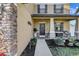 Inviting front porch with decorative plants, a cozy seating area, and stone accents at 4010 Lindever Ln, Palmetto, FL 34221