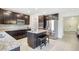 Open kitchen featuring stainless steel appliances, dark cabinets, and a center island with bar stools at 4010 Lindever Ln, Palmetto, FL 34221