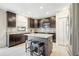 Modern kitchen with stainless steel appliances, dark cabinets, and a center island with seating at 4010 Lindever Ln, Palmetto, FL 34221