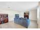 Cozy living room features stylish furniture, an entertainment center, and tile flooring at 4010 Lindever Ln, Palmetto, FL 34221