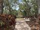 Picturesque garden with a tiered fountain, lush plants, and charming benches, creating a serene outdoor retreat at 4166 Central Sarasota Pkwy # 535, Sarasota, FL 34238