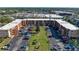 Aerial view of a well-maintained condominium complex with parking and green space at 4186 Heron Way # B-219, Bradenton, FL 34205