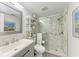 Bright bathroom featuring a glass enclosed shower with marble tiling and modern sink at 4186 Heron Way # B-219, Bradenton, FL 34205