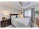 Bedroom with a ceiling fan, window with blinds, and two nightstands at 4186 Heron Way # B-219, Bradenton, FL 34205