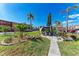 Inviting community green space with outdoor seating, lush landscaping, and swaying palm trees at 4186 Heron Way # B-219, Bradenton, FL 34205
