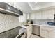 This is a close up of a bright kitchen with mosaic backsplash and modern appliances at 4186 Heron Way # B-219, Bradenton, FL 34205