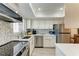 Bright kitchen with white cabinets, mosaic tile backsplash, stainless steel appliances, and sleek countertops at 4186 Heron Way # B-219, Bradenton, FL 34205