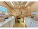 Well-lit laundry room with multiple washing machines and helpful posted instructions at 4186 Heron Way # B-219, Bradenton, FL 34205