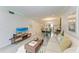 Inviting living room with tile flooring and a television at 4186 Heron Way # B-219, Bradenton, FL 34205