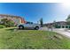 Parking area with a view of a residential building and directional signage at 4186 Heron Way # B-219, Bradenton, FL 34205