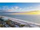 Overhead view of the ocean and beach with beachgoers on a clear day at 4225 Overture Cir, Bradenton, FL 34209