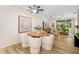 Bright dining area featuring a modern light fixture, wood floors and an adjacent living space at 4225 Overture Cir, Bradenton, FL 34209