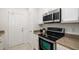 Efficient kitchen layout with white cabinets, stainless steel appliances, and light countertops at 4225 Overture Cir, Bradenton, FL 34209