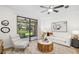 Bright living room with a ceiling fan and sliding glass doors leading to the outside at 4225 Overture Cir, Bradenton, FL 34209