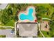 Overhead view of a bright blue pool, lounge seating, playground, and clubhouse area at 4225 Overture Cir, Bradenton, FL 34209