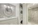 Stylish bathroom featuring granite counters, under sink cabinets, and a convenient washer and dryer at 4380 Exeter Dr # H202, Longboat Key, FL 34228