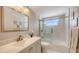 Bright bathroom featuring a new vanity, framed mirror, and glass shower doors at 4380 Exeter Dr # H202, Longboat Key, FL 34228