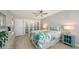 Inviting bedroom showcasing a bed with leafy patterned bedding, white closet doors, and a side table at 4380 Exeter Dr # H202, Longboat Key, FL 34228