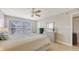 Comfortable bedroom featuring a leafy bedspread, neutral walls, and a large window with serene views at 4380 Exeter Dr # H202, Longboat Key, FL 34228