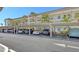 Well-maintained carport with ample parking, complemented by lush palm trees and exterior condo architecture at 4380 Exeter Dr # H202, Longboat Key, FL 34228