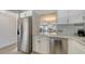 Modern kitchen with views to the living and dining areas with stainless appliances and quartz counters at 4380 Exeter Dr # H202, Longboat Key, FL 34228