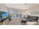 Bright living room with sliding glass doors to the balcony, comfortable seating, and serene water views at 4380 Exeter Dr # H202, Longboat Key, FL 34228