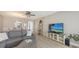 Relaxing living room with a sectional sofa, dining area, and entertainment center, offering comfortable coastal living at 4380 Exeter Dr # H202, Longboat Key, FL 34228
