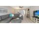 Spacious living room with modern furniture, wood-look flooring, and a view of the dining area at 4380 Exeter Dr # H202, Longboat Key, FL 34228
