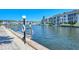 Scenic waterfront view with a boat dock, beautiful condos, and clear blue sky, perfect for a relaxing coastal lifestyle at 4380 Exeter Dr # H202, Longboat Key, FL 34228