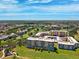 Panoramic aerial view of condo buildings set on a golf course with ponds and green fairways at 4410 Fairways Blvd # 605, Bradenton, FL 34209