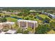 Scenic aerial view of condo buildings, golf course, and ponds surrounded by mature trees and neighborhood at 4410 Fairways Blvd # 605, Bradenton, FL 34209