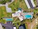 An aerial view of the pool and amenity spaces with tennis courts and shuffleboard at 4410 Fairways Blvd # 605, Bradenton, FL 34209