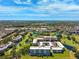 Overhead view of condo buildings, manicured golf course with water features and surrounding community at 4410 Fairways Blvd # 605, Bradenton, FL 34209