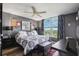 Stylish bedroom featuring a large bed, unique artwork, and a window with a view of the outdoors at 4410 Fairways Blvd # 605, Bradenton, FL 34209