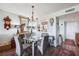 Cozy dining room with glass table, neutral decor, and pass through to kitchen at 4410 Fairways Blvd # 605, Bradenton, FL 34209