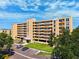 Beige mid-rise building featuring multiple stories with balconies, ample parking, and well-maintained landscaping at 4410 Fairways Blvd # 605, Bradenton, FL 34209