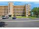 A large condo building with parking in front is enhanced by lush landscaping at 4410 Fairways Blvd # 605, Bradenton, FL 34209