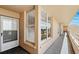 Well lit hallway with large windows displaying serene views along with a white front door at 4410 Fairways Blvd # 605, Bradenton, FL 34209