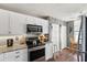 Bright kitchen features white cabinetry, granite countertops, and stainless steel appliances at 4410 Fairways Blvd # 605, Bradenton, FL 34209