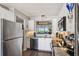 Modern kitchen featuring stainless steel appliances, granite counters, and pass through to dining area at 4410 Fairways Blvd # 605, Bradenton, FL 34209